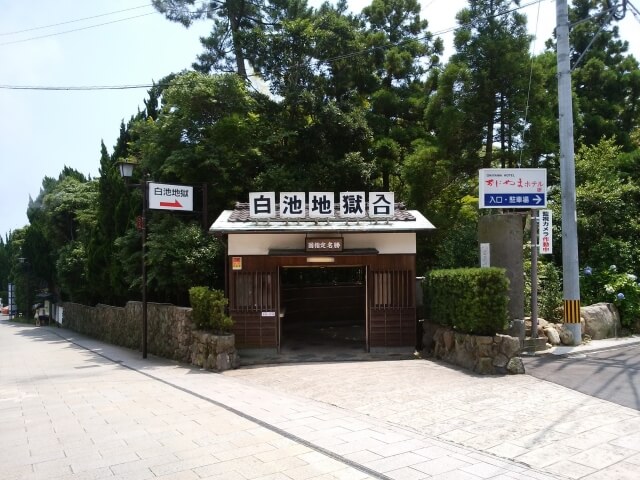 白池地獄の入口看板と和風庭園の風景
